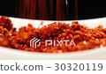 Falling chilli powder on a dish 30320119