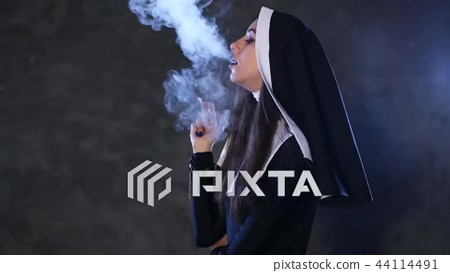 Sexy nun smokes a cigarette - Stock Footage