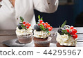 Baker decorating tasty cupcake. Icing sugar... - Stock Footage [44295967]