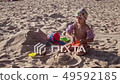 Beautiful Little Girl Playing in sand On... - Stock Footage [49592185]