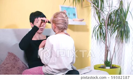 Mom lesbian preparing daughter for school in the - Stock Footage 