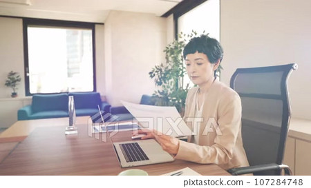 Slider shot of a woman comparing paper... - Stock Footage