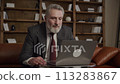 Affirmative Businessman at Laptop in Office 113283867