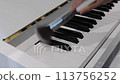 Dusting dust off piano keys with a brush, cleaning piano keys, dusting piano keys 113756252